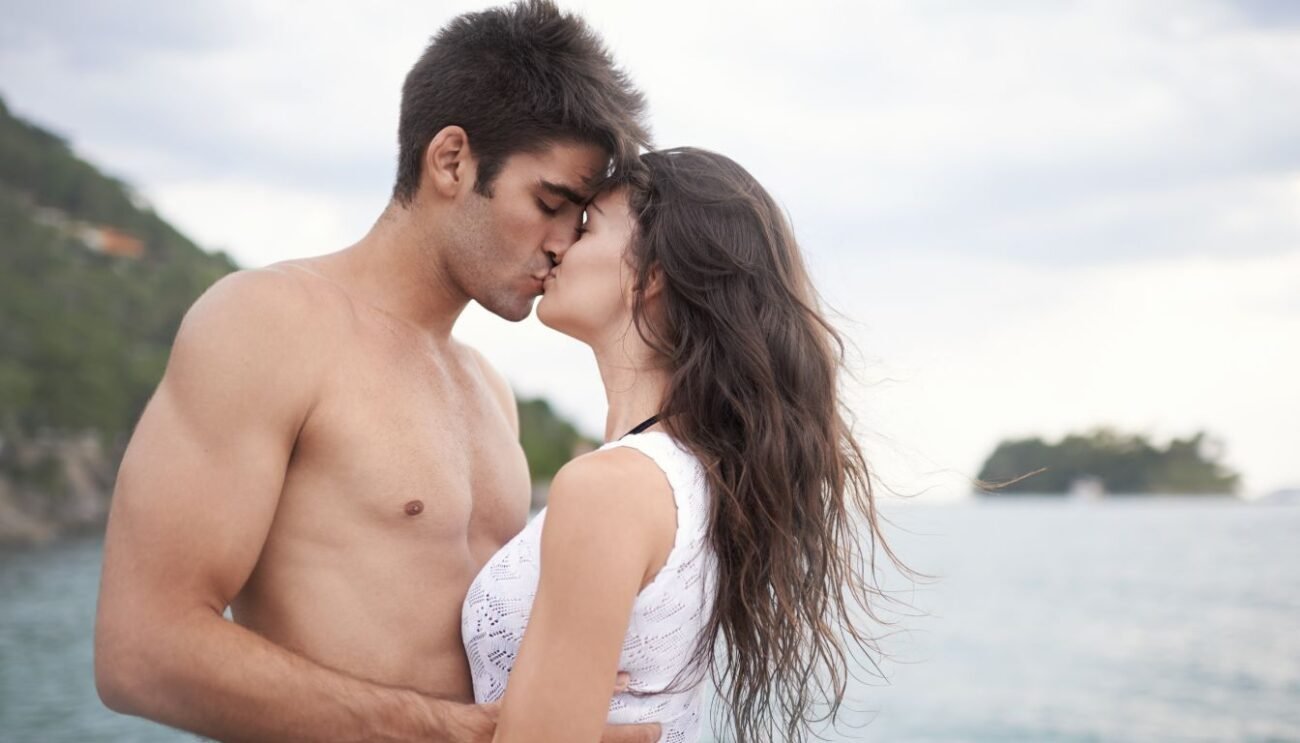 image shows a pair kissing lip lock in